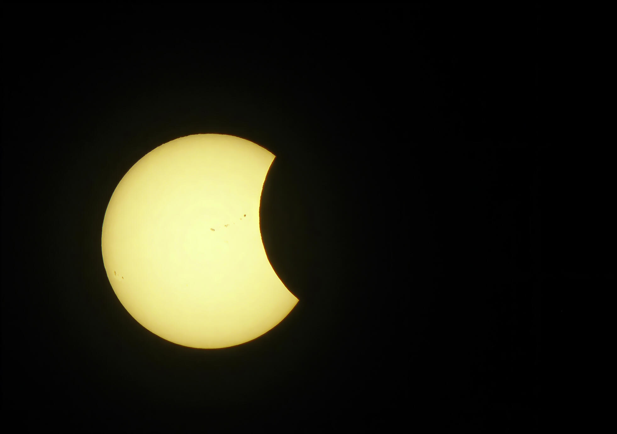 A striking moment during the 2017 solar eclipse, as the Moon takes a dramatic bite from the glowing Sun. Photographed in Toronto, Canada, on August 21, 2017.
